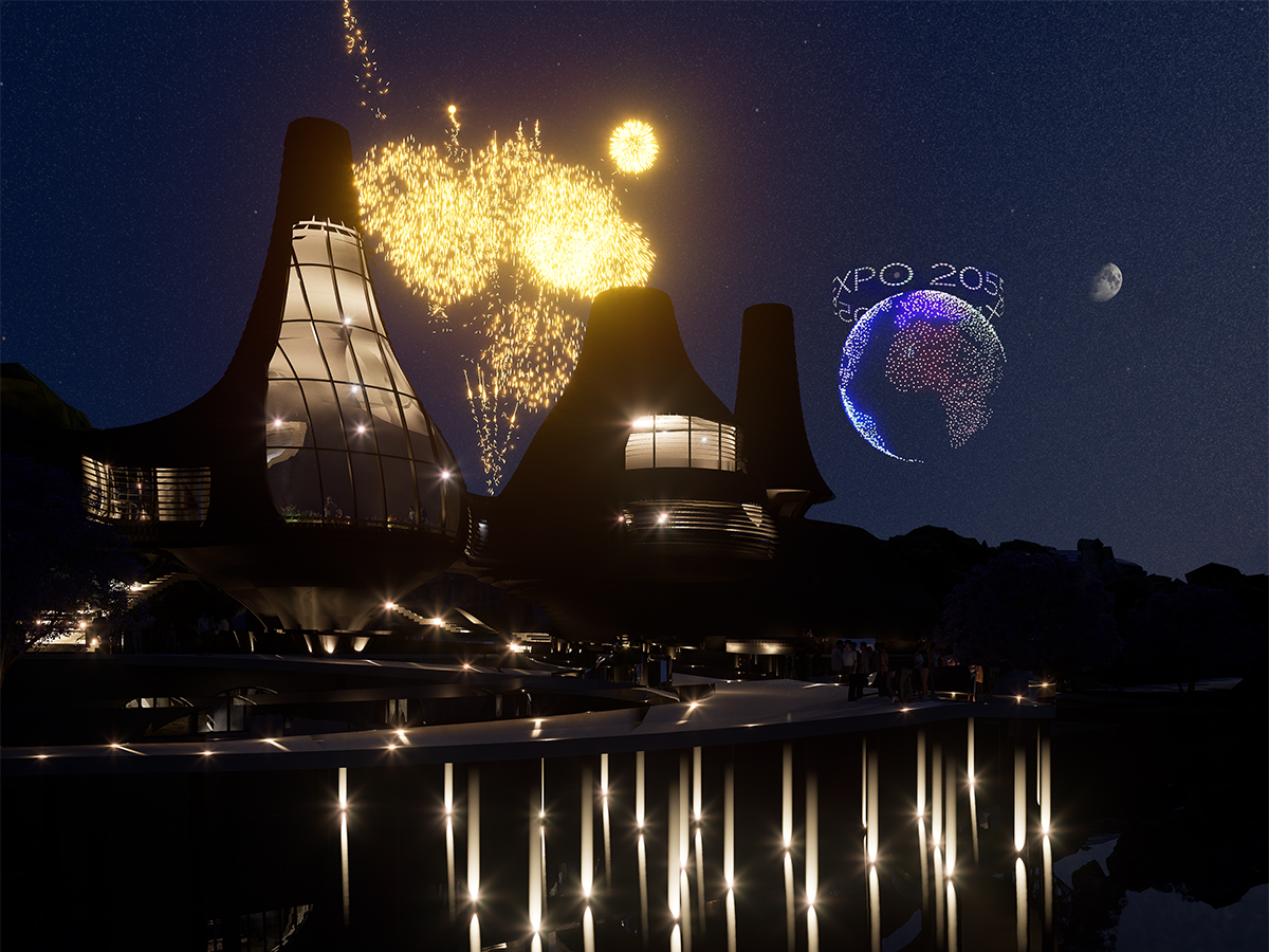 Visual showing the building during the expo at night, with fireworks and a drone display in the background.